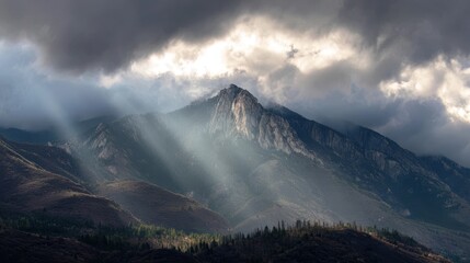 Majestic mountain peak sunrise, crepuscular rays, autumnal valley