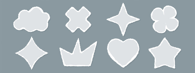 A set of cut out paper shapes with rough, torn edges. Stickers include hearts, crowns, clouds, and stars. Vector templates.