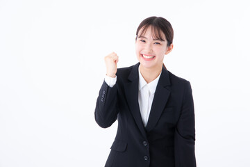 ガッツポーズするスーツを着た若い女性