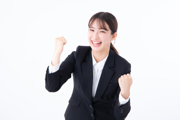 ガッツポーズするスーツを着た若い女性
