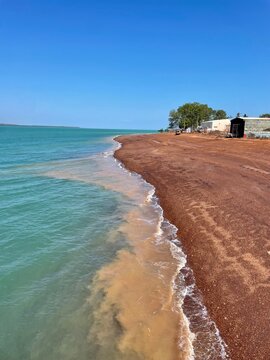 Where the red earth meets turquoise waters &mdash; a coastline carved by nature&rsquo;s contrasts, glowing under the tropical sun. North Australia