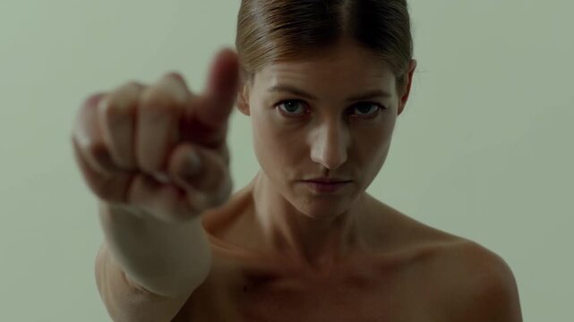 Montage of a serious woman pointing her finger towards the viewer, isolated on a white background, creating a sense of accusation or warning