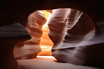 Sunlight streams into a narrow sandstone slot canyon
