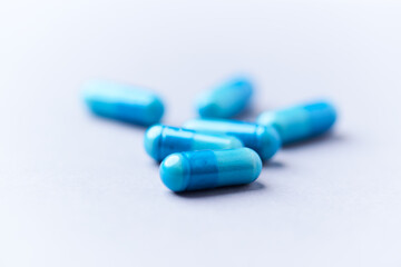 Amino acids capsules on bright background. Soft focus. Close up. Copy space.	