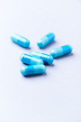 Amino acids capsules on bright background. Soft focus. Close up. Copy space.	