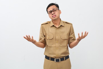 Frustrated Indonesian civil servant man standing with sad face expression