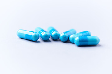 Amino acids capsules on bright background. Soft focus. Close up. Copy space.	