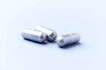 Amino acids capsules on bright background. Soft focus. Close up. Copy space.	