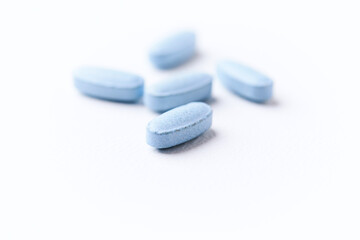 Multivitamin tablets on bright paper background. Close up. Copy space	