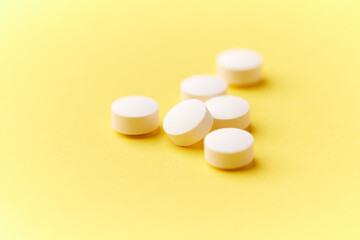 Hyaluronic acid tablets. Hyaluronic acid helps skin stretch and flex and reduces skin wrinkles. Bright paper background. Soft focus. Close up. Copy space	