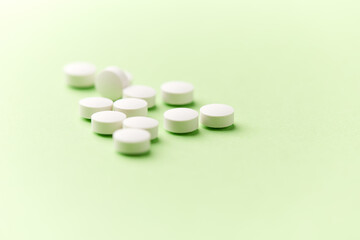 Hyaluronic acid tablets. Hyaluronic acid helps skin stretch and flex and reduces skin wrinkles. Bright paper background. Soft focus. Close up. Copy space	