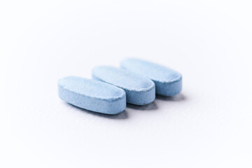 Multivitamin tablets on bright paper background. Close up. Copy space	