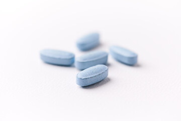 Multivitamin tablets on bright paper background. Close up. Copy space	