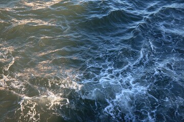 Rippled sea surface with foamy waves