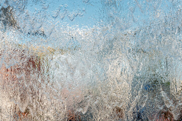 Aqua background. Product space next to clean water streams and water splashes and drops.