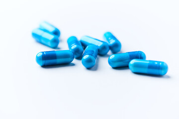 Amino acids capsules on bright background. Soft focus. Close up. Copy space.	