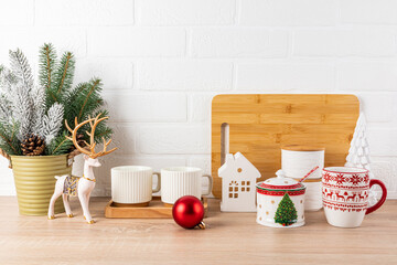 The wooden kitchen countertop is decorated for the New Year and Christmas holidays in a minimalist...