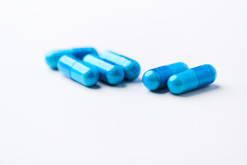Amino acids capsules on bright background. Soft focus. Close up. Copy space.	