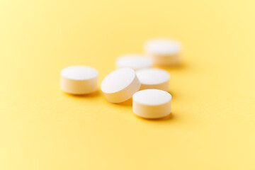 Hyaluronic acid tablets. Hyaluronic acid helps skin stretch and flex and reduces skin wrinkles. Bright paper background. Soft focus. Close up. Copy space	