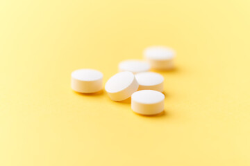 Hyaluronic acid tablets. Hyaluronic acid helps skin stretch and flex and reduces skin wrinkles. Bright paper background. Soft focus. Close up. Copy space	