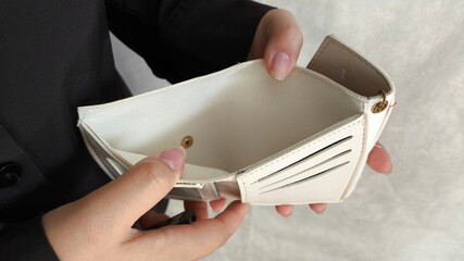 Close-up person opening empty wallet showing broke financial in debt from over expenses. The...