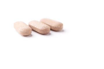 Ashwagandha (Withania somnifera) tablets on paper background. Soft focus. Close up. Copy space.	