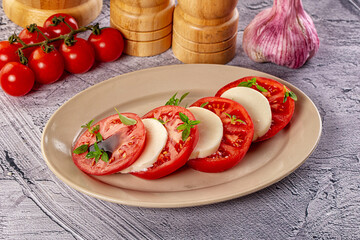 Italian caprese salad with mozzarella, tomato and basil