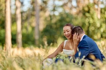 Fototapeta premium Romantic Outdoor Wedding Couple Sharing Intimate Moment in Scenic Nature Setting