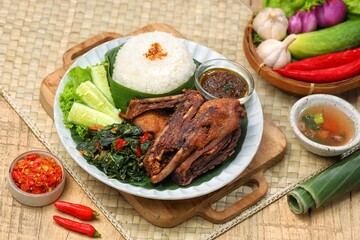 Bebek goreng bumbu hitam. Madura's signature black spiced duck is savory and spicy