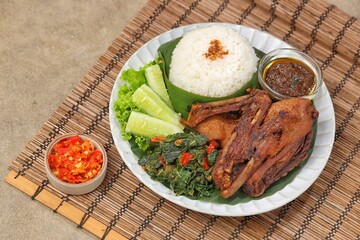 Bebek goreng bumbu hitam. Madura's signature black spiced duck is savory and spicy