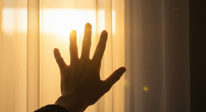 Human hand reaching towards warm golden sunlight through transparent curtains - Powered by Adobe