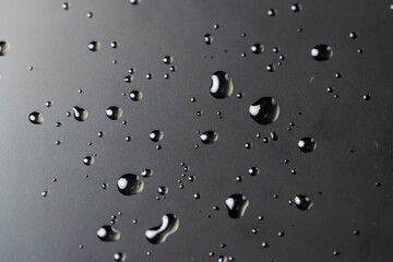 protective soft film glued to the touch screen of a modern device covered with water droplets