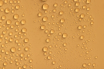 the surface is orange , covered with water droplets , and there is a beautiful wet yellow film with a large number of water droplets