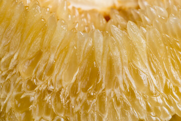 sweet citrus fruit peeled, pieces of delicious and sweet citrus fruit while preparing it for...