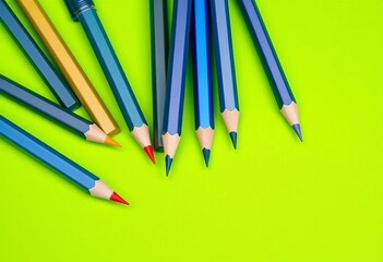 Fototapeta premium Several sharpened pencils arranged on a vibrant green surface, office, texture