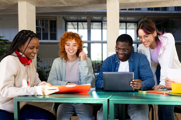 Plakat University students collaborating on a project using laptop and documents