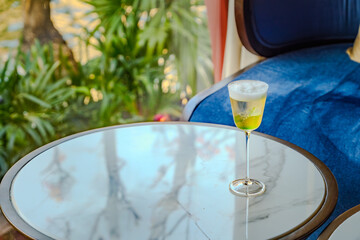 a clear sparkling golden cocktail liquor in Cordial glass serving in evening bar