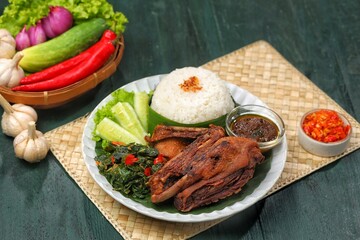Bebek goreng bumbu hitam. Madura's signature black spiced duck is savory and spicy