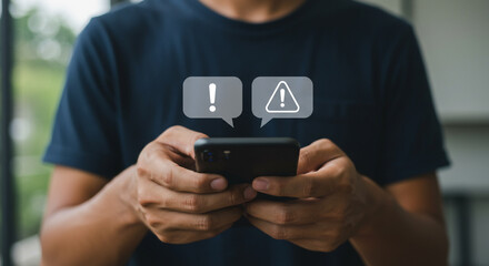 Person holding a smartphone displaying notification alerts and warning symbols on screen
