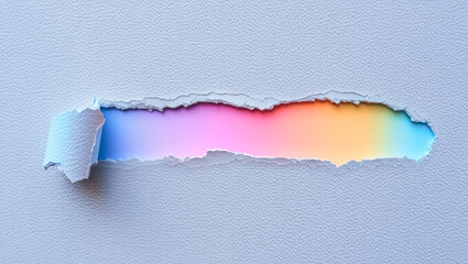 Torn paper revealing a vibrant rainbow spectrum, symbolizing hope, creativity, and the breaking of limitations.