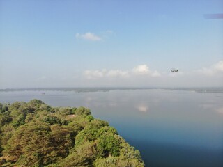 Camouflage colour bell 212 helicopter in hover over a large water tank and ready for departure	