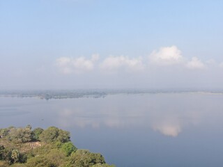 Camouflage colour bell 212 helicopter in hover over a large water tank and ready for departure	