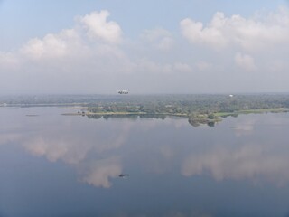 Camouflage colour bell 212 helicopter in hover over a large water tank and ready for departure	