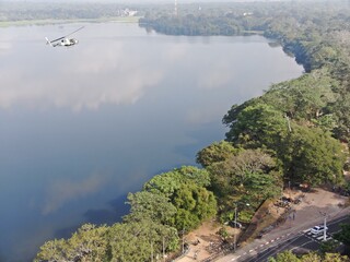 Camouflage colour bell 212 helicopter in hover over a large water tank and ready for departure	