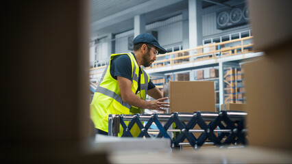Multiethnic Male Loader Putting Boxes On Automated Conveyor Belt In Modern Distribution Warehouse....