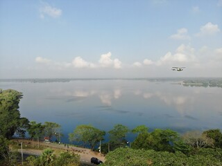 Camouflage colour bell 212 helicopter in hover over a large water tank and ready for departure	
