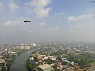 Camouflage colour bell 212 helicopter in hover over a large water tank and ready for departure	