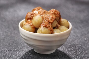 Cilok with spicy peanut sauce, a snack with a chewy and savory texture, with a spicy taste that burns the tongue