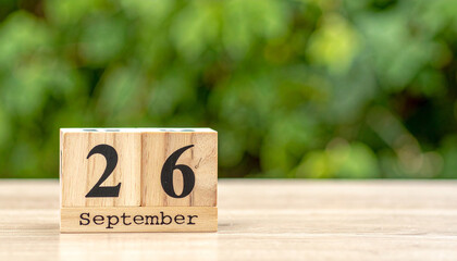 Wooden block calendar displaying September 26, date reminder. World Maritime Day