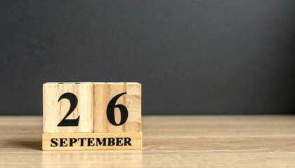 Wooden block calendar displaying September 26, date reminder. World Maritime Day